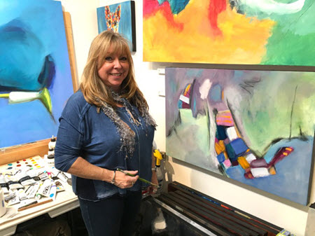 Debbie Lynch working on a large abstract canvas